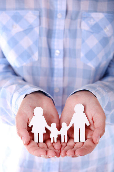 female-hands-holding-toy-family-closeup