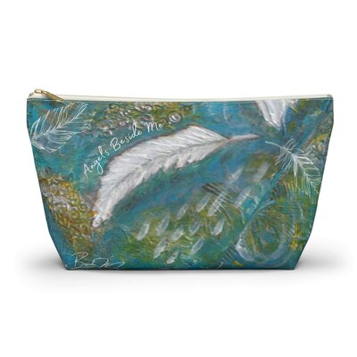 Painting of white feather on a blue canvas pouch