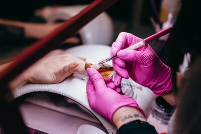 A nail tech sculpts a nail in a private nail salon