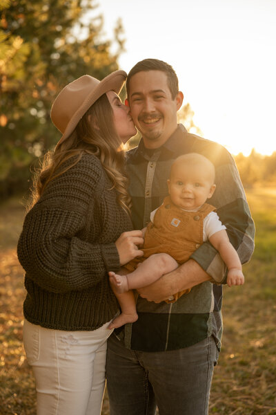 mom and dad with their son in golden hour by cda photographer