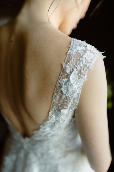 detail portrait of the back of a bride in her dress
