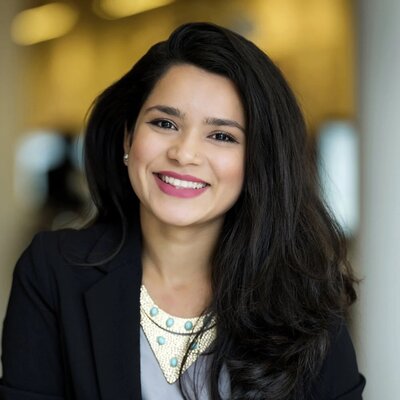Smiling woman with long dark hair in a business suit, professional headshot for LinkedIn in Bergen County, NJ.