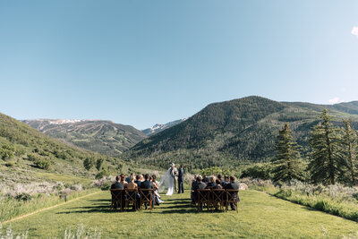 Bride and groom walking hand-in-hand in front of vibrant bougainvillea, captured by a Scottsdale wedding photographer in a scenic outdoor wedding venue.