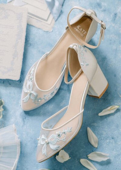 white and blue embroidered shoes