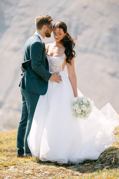 Capture the happiness of a bride and groom walking through the main hall of the Banff Springs Hotel after their wedding ceremony. A beautiful moment of love and joy in an iconic setting.