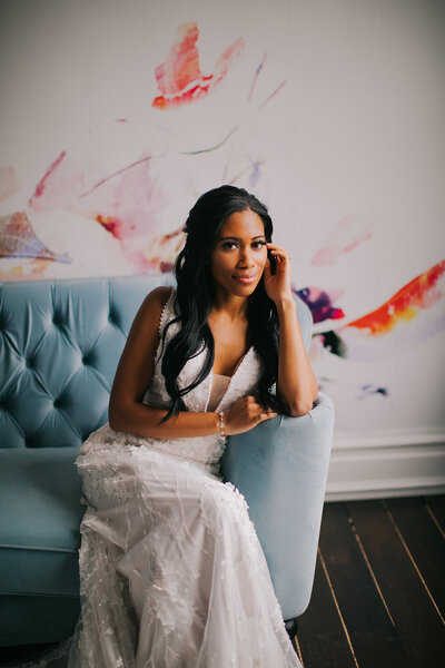 Bride sits on couch at Covenant at Murray Mansion  wedding