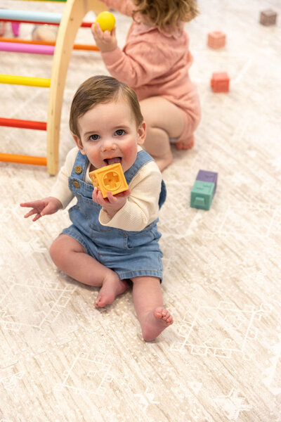 Baby playing with a block