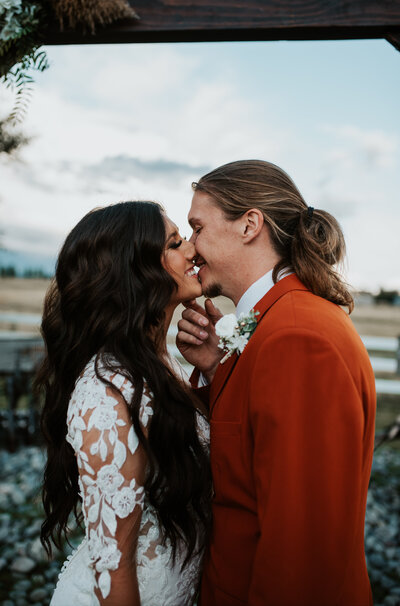 smiling newlyweds sharing a kiss at their Wyoming wedding