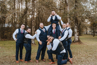 groom surrounded by groomsmen