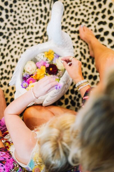 A woman arranging flowers, creating beauty and harmony with thoughtful care and intention.