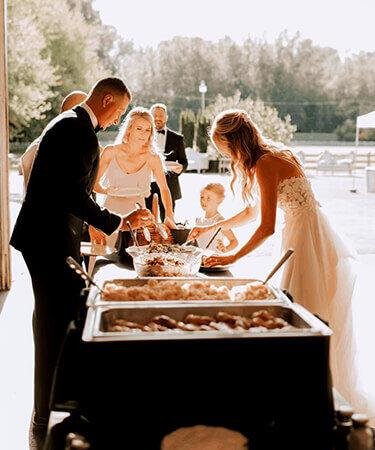 Newlyweds serving from a personalized wedding menu