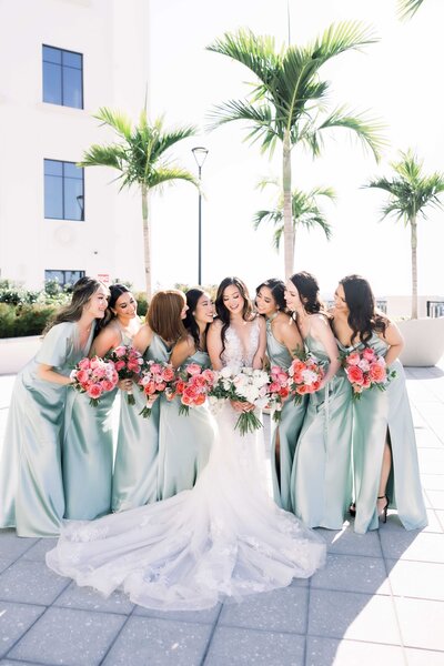 Bridesmaids in light green dresses at Loews Coral Gables hotel in Miami