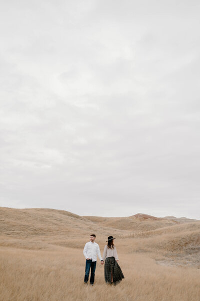 Couple holding hands in the Badlands