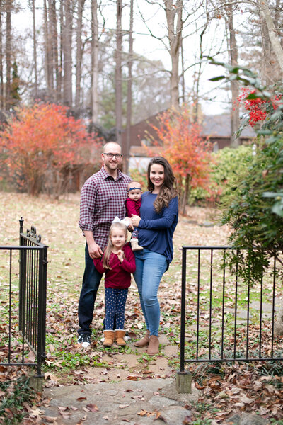 Kennesaw family stands close in beautiful fall folliage