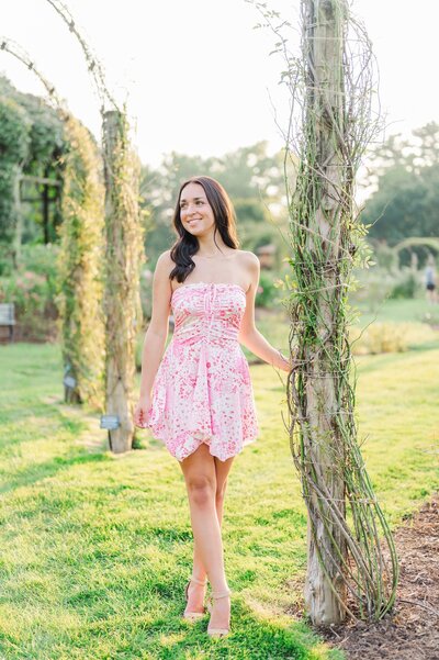A girl smiles into the distance in Elizabeth Park. 