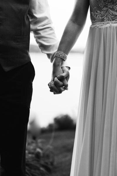 bride and groom holding hands