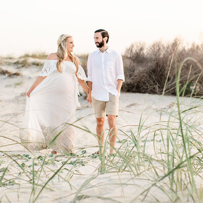 pregnant woman in beautiful dress at a breathtaking beach location in Florida