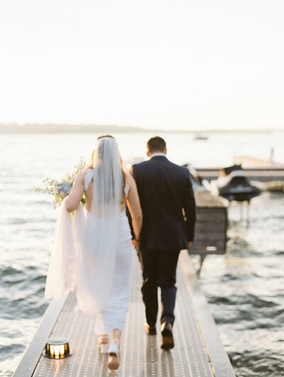 husband and wife sitting in an old rolls royce with their foreheads touching and smiling at one another
