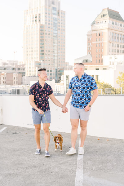 an engaged lgbtq couple holds hands while touching their foreheads together during their Carmel by the Sea engagement session.