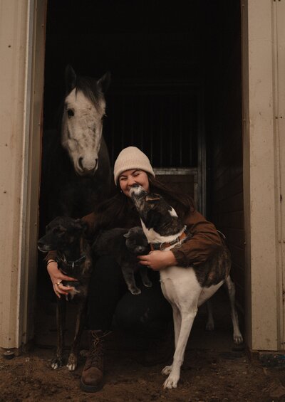 organic branding image of female photographer enjoying a playful moment with her animals at her home