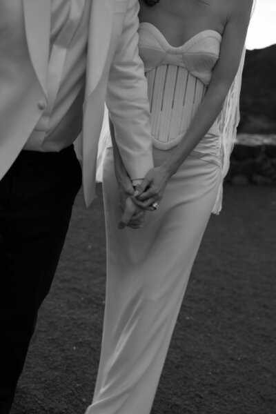 Modern bride and groom holding hands