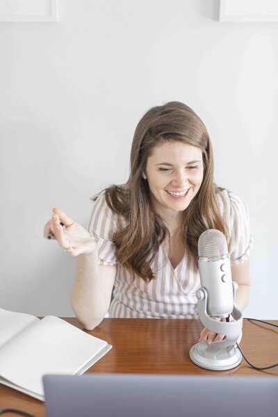 Woman at desk taking on mic