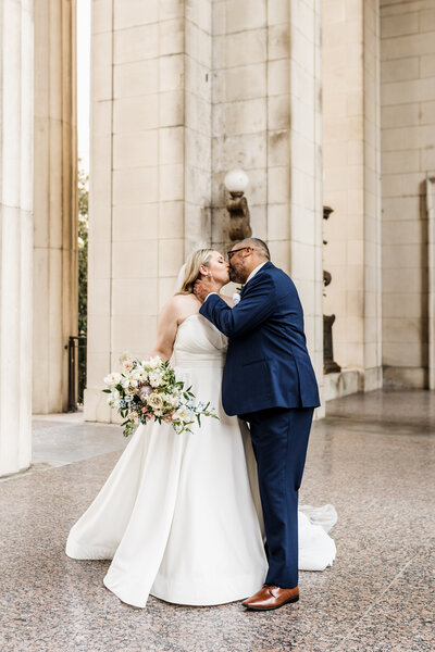 couple kissing near columns