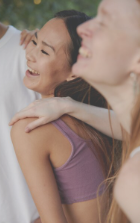 Woman turned away from camera and laughing with friends.