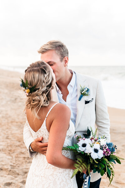 bride and groom kissing on the beach in Southern Shores, NC