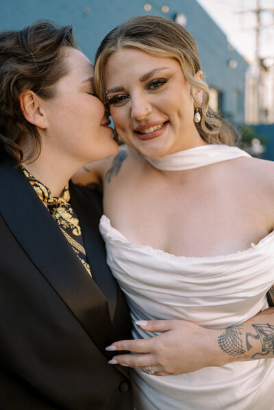 Bride and groom smile with their foreheads together on a rooftop in Chicago