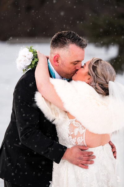 Bride and Groom kiss winter wonderland wedding in Edmonton