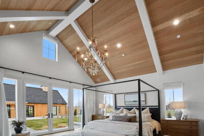 Luxury bedroom design with statement lighting by Idaho Luxury Custom Home builder Thompson Homes