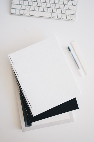 Blank notebook and ruler on a minimalist desk