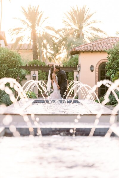 Wedding at Omni Montelucia Scottsdale Bride and Groom Kissing  by fountain