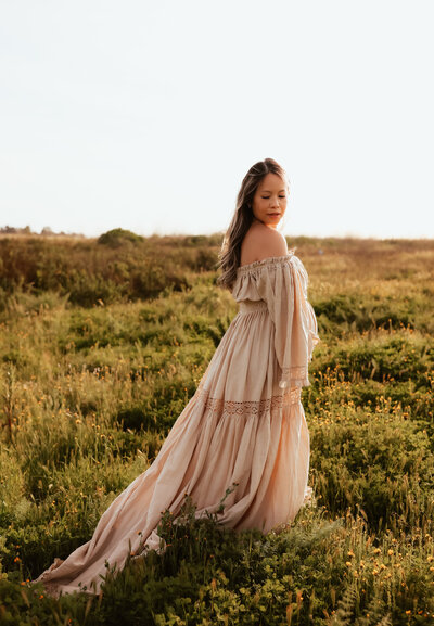A family of four walking through a stunning wildflower field at golden hour. 