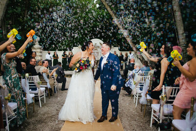 An LGBTQ+ couple engulfed in bubbles leaving their Washington wedding ceremony.