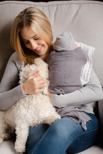 mother snuggling dog and newborn baby by carrie pellerin
