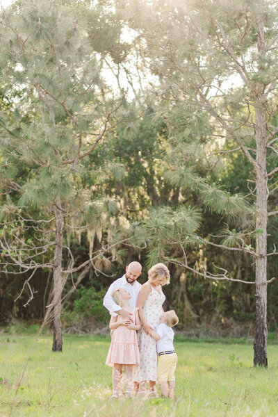 Family of 4 in large field at state park during spring family session
