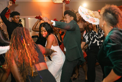 Bride and groom dance the night away at their reception surrounded by friends and family, as their Sarasota photographers snap away!