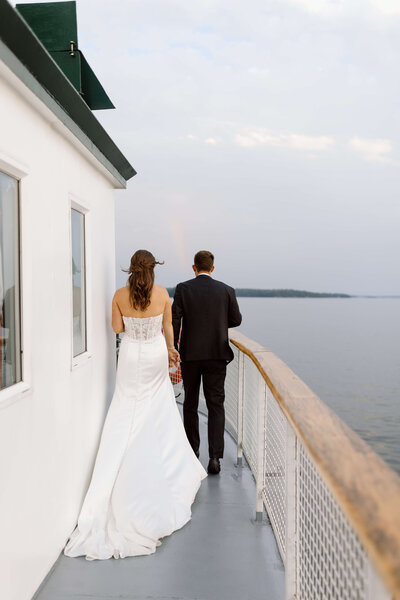 A couple walking on the top deck of a Muskoka Steamship based in Gravenhurst, Ontario.