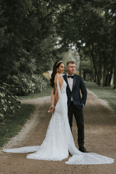A bride and groom posing for photos on their wedding day at Wheatfield Estate.