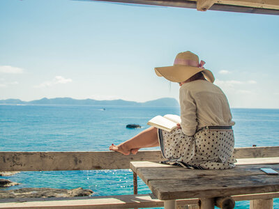 Woman on a boat in a bikini and sunhat