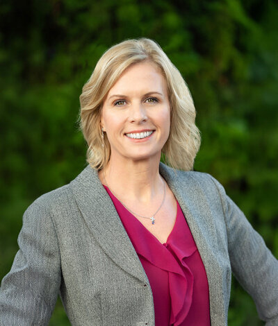 air service professional woman in grey blazer pink shirt smiling