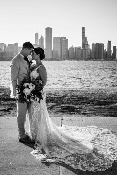 Bride and groom share a romantic moment at the Adler Planetarium in Chicago, IL