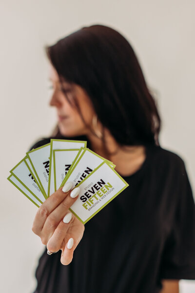 Kirstin holding Studio Seven Fifteen business cards during brand photoshoot