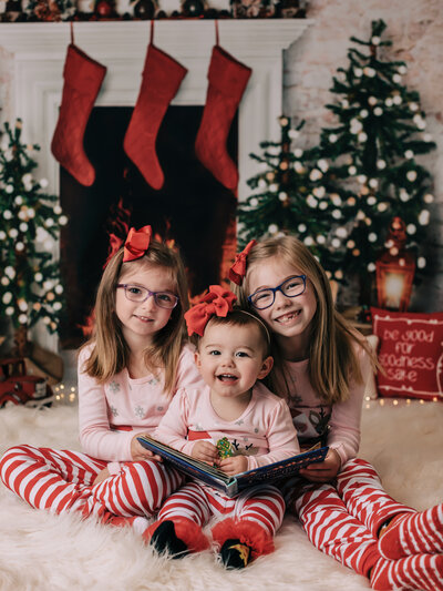 three sisters in christmas pajamas for stuido portrait in richfield ohio