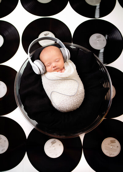 Modern record-themed newborn photography session in Overland Park, Kansas. A timeless choice for families seeking creative Kansas City newborn photographers.