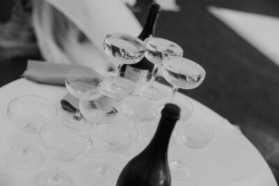 black and white detail image of cocktail classes and wine bottles