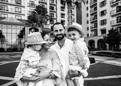 Black and white photo with family with two little boys laughing