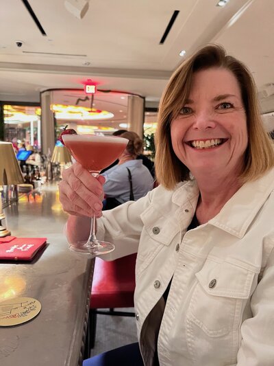 Photo of Kelly with a drink at a restaurant
